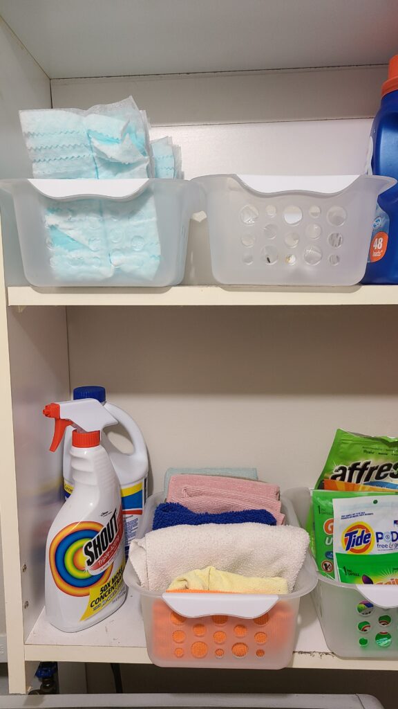 A small organizing bin filled with Swiffer duster refills.