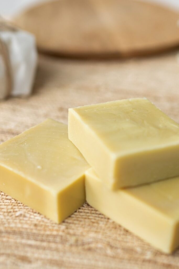 3 unwrapped bars of soap, laying on a bamboo mat