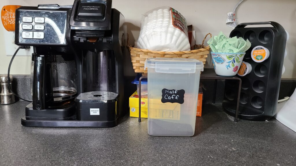 A coffee station on a kitchen countertop.