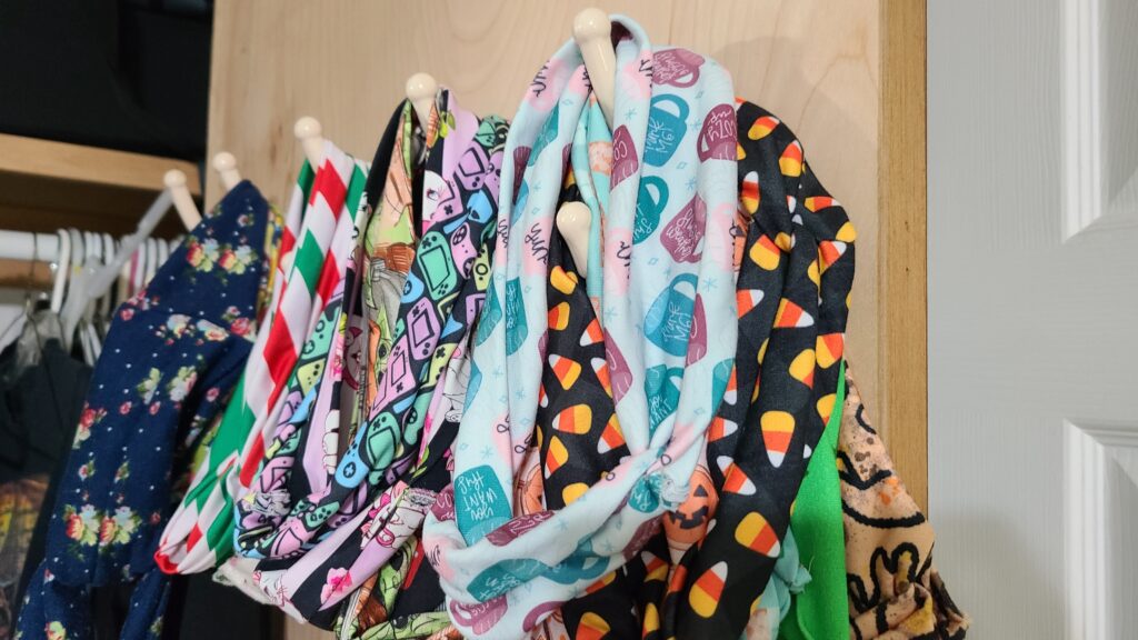 Headbands hanging on a door hook inside a closet door.