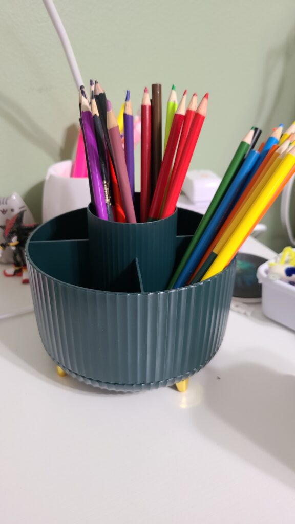 A Lazy Susan on a desk, filled with colored pencils