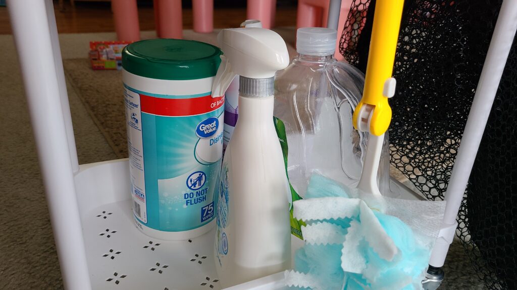 The bottom of a rolling cart, filled with miscellaneous cleaning supplies.