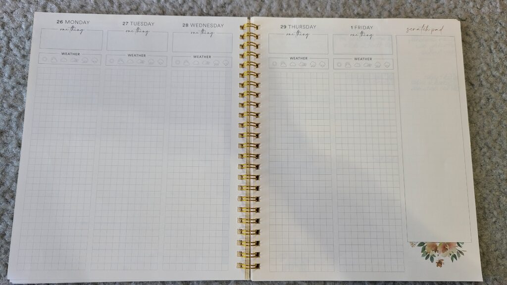 An opened Silk and Sonder planner, opened up to the daily spread pages