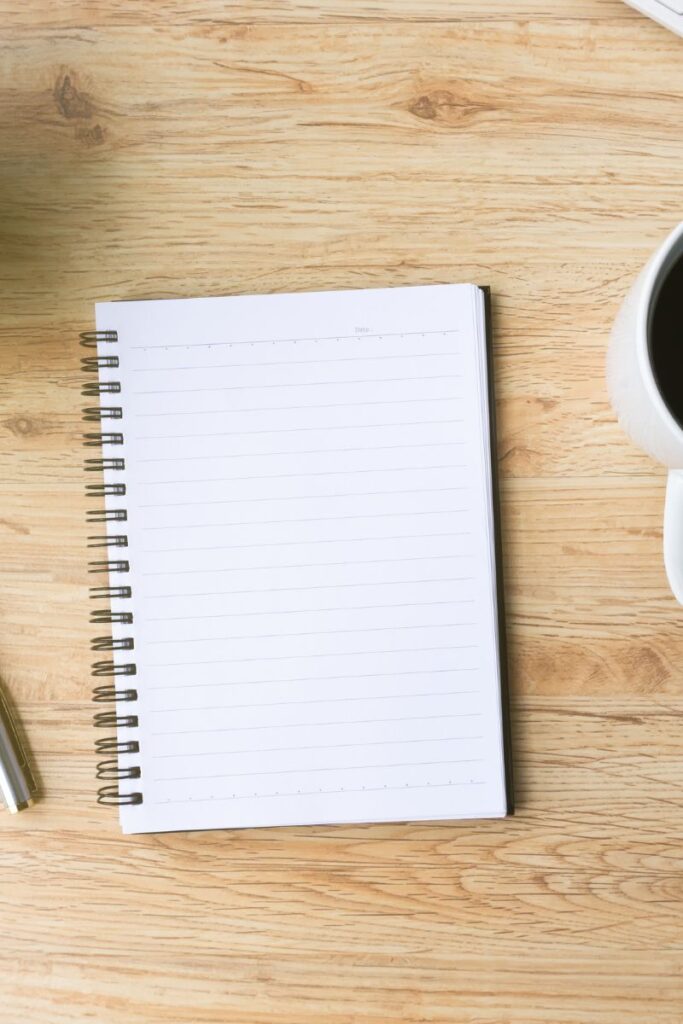 A blank notebook laying on a wooden surface