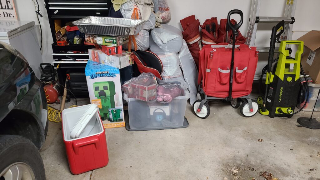 The inside of a garage, focused on a donation bin filled with items